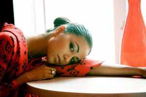 Karen David with black hair and head on the table.jpg